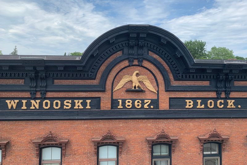 Up close photo of Winooski Block brick building with trim painted black